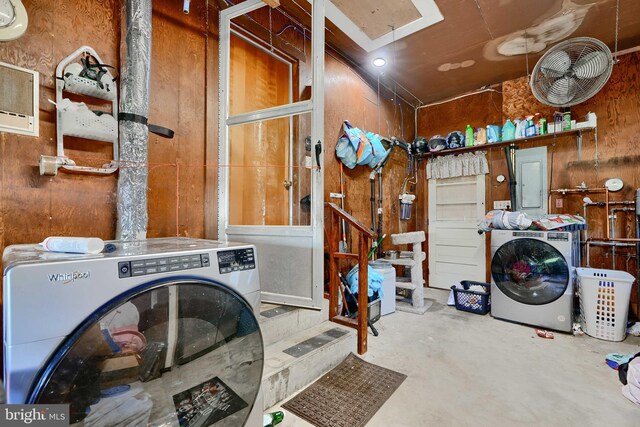 washroom with laundry area, washer and clothes dryer, and electric panel