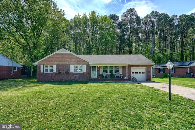 ranch-style house featuring brick siding, a garage, a front lawn, and concrete driveway