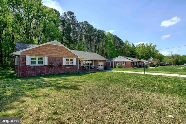 single story home with brick siding, an attached garage, driveway, and a front yard
