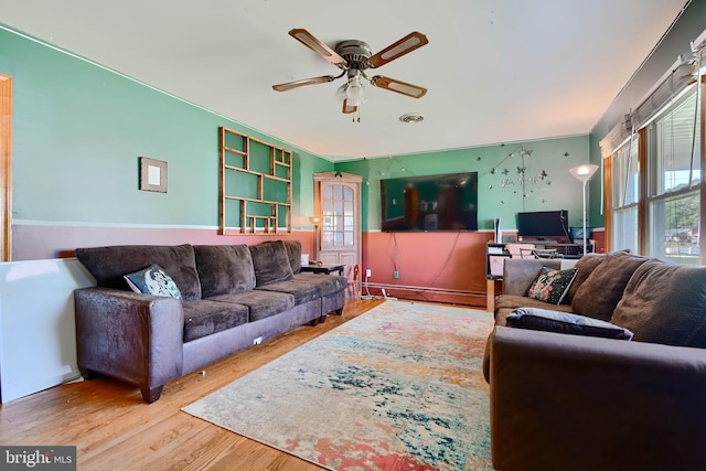 living area featuring visible vents, ceiling fan, and wood finished floors