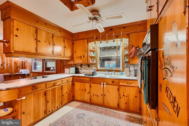 kitchen featuring brown cabinetry, a sink, and light countertops