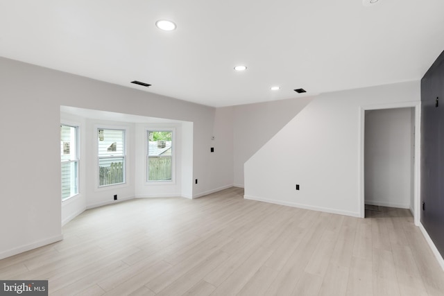 unfurnished living room with recessed lighting, baseboards, visible vents, and light wood-style floors