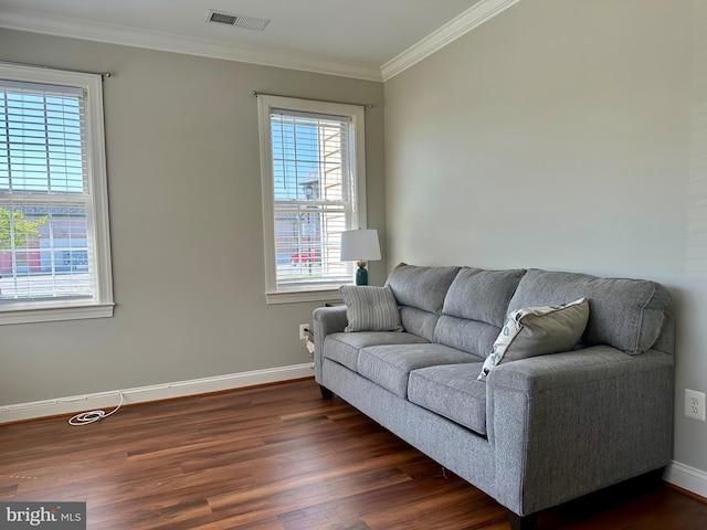 living area with crown molding, baseboards, visible vents, and dark wood-style floors