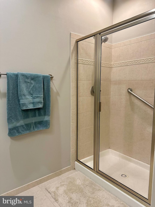 bathroom featuring tile patterned flooring and a shower stall
