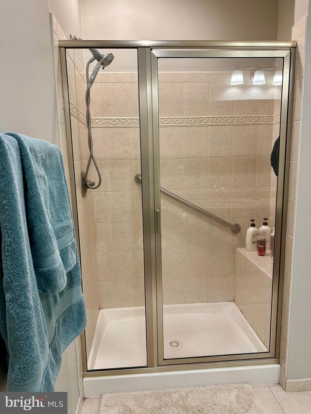 bathroom with tile patterned floors and a stall shower