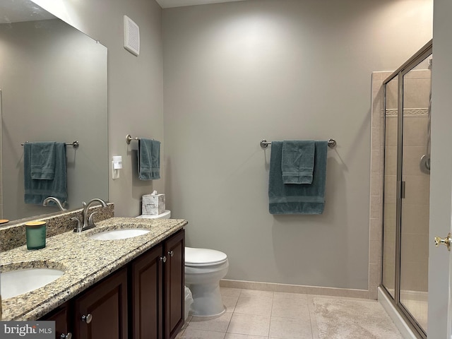 bathroom with baseboards, a sink, toilet, and a shower stall