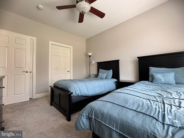 bedroom with light colored carpet, a ceiling fan, and baseboards