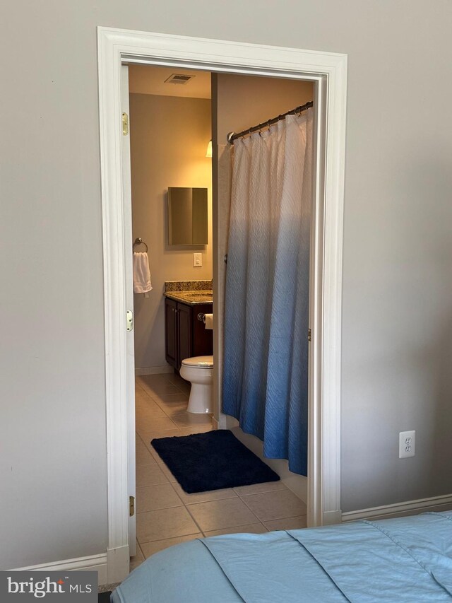 full bathroom featuring tile patterned floors, baseboards, and vanity