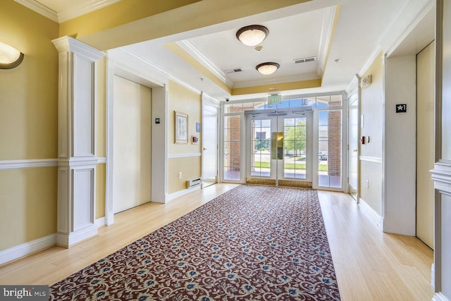 interior space featuring crown molding, visible vents, french doors, and wood finished floors