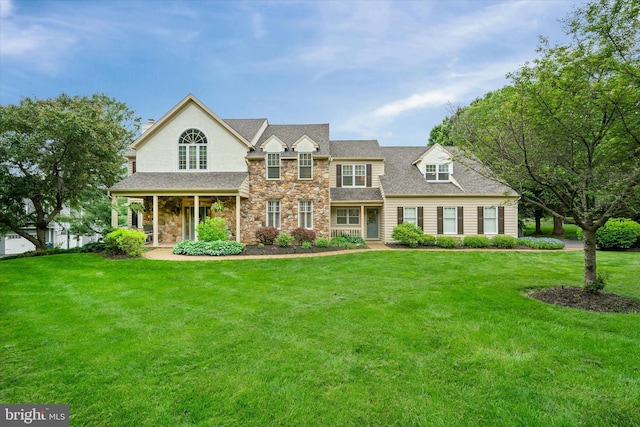 723 Ann Dr, Kennett Square, PA 19348 - view of front facade with stone siding, a front yard, and a porch
