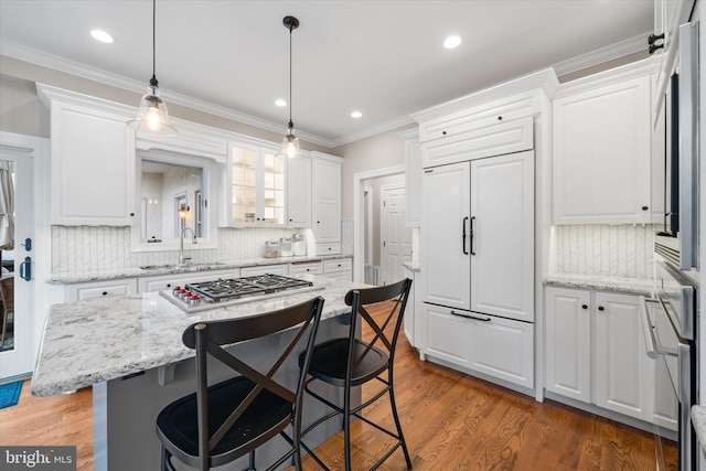 723 Ann Dr, Kennett Square, PA 19348 - kitchen featuring stainless steel gas cooktop, white cabinetry, a kitchen breakfast bar, recessed lighting, and crown molding
