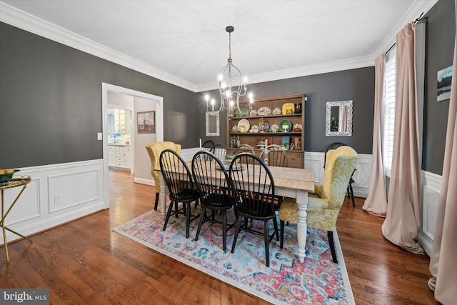 723 Ann Dr, Kennett Square, PA 19348 - dining area with a chandelier, wainscoting, a decorative wall, crown molding, and dark wood-style flooring