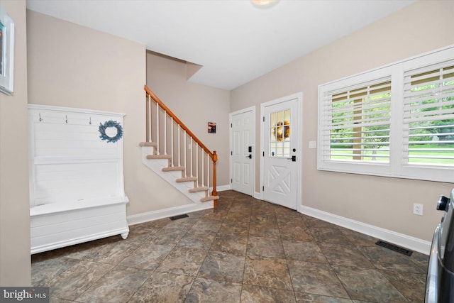 723 Ann Dr, Kennett Square, PA 19348 - foyer entrance with baseboards, stairs, and stone finish flooring