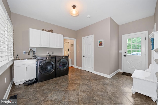 723 Ann Dr, Kennett Square, PA 19348 - laundry area featuring washer and clothes dryer, cabinet space, baseboards, and dark stone finish floors
