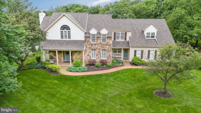 723 Ann Dr, Kennett Square, PA 19348 - view of front of home featuring covered porch, a shingled roof, stone siding, and a front lawn