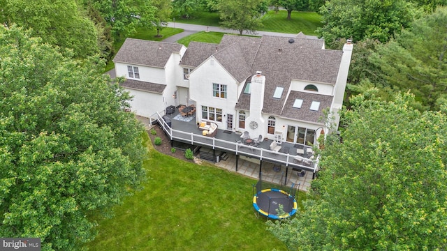 723 Ann Dr, Kennett Square, PA 19348 - back of house featuring a chimney, an outdoor living space, a lawn, a deck, and a trampoline