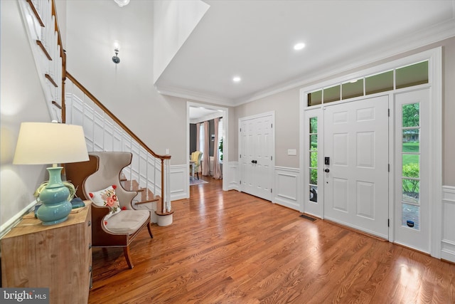 723 Ann Dr, Kennett Square, PA 19348 - foyer with ornamental molding, a decorative wall, wainscoting, stairs, and wood finished floors