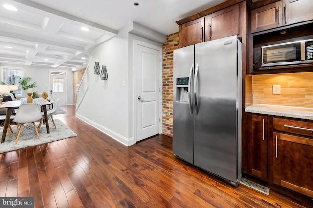 kitchen featuring dark wood-style flooring, appliances with stainless steel finishes, light stone countertops, baseboards, and coffered ceiling