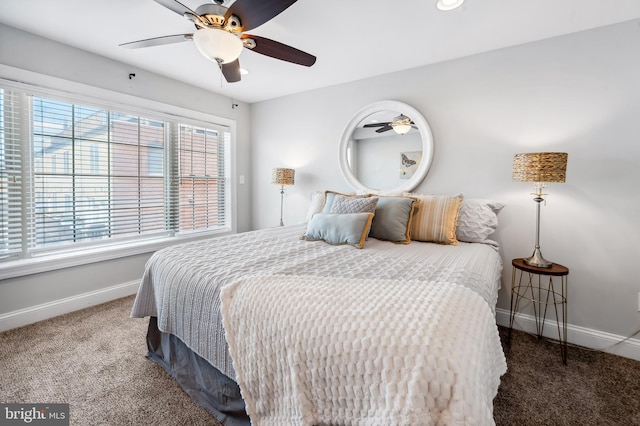 carpeted bedroom featuring baseboards and ceiling fan