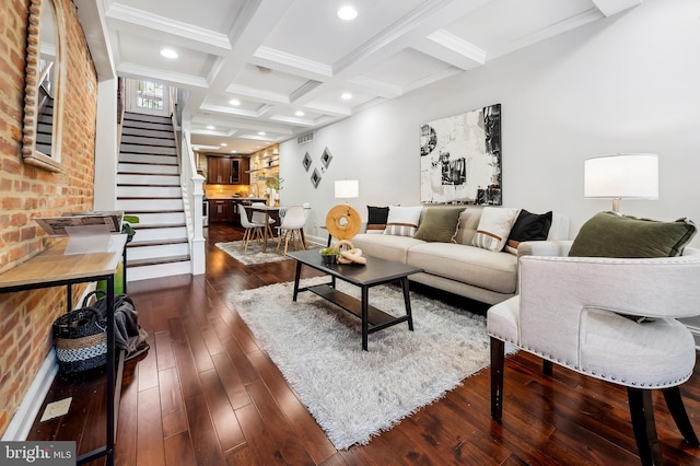 living room with crown molding, beamed ceiling, coffered ceiling, stairs, and dark wood-type flooring