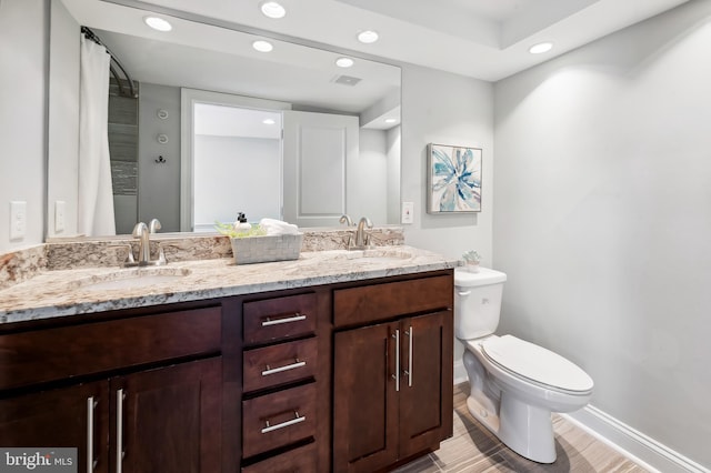 bathroom featuring a sink, recessed lighting, toilet, and visible vents