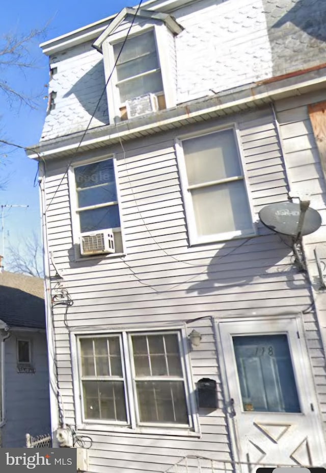 view of side of property with cooling unit