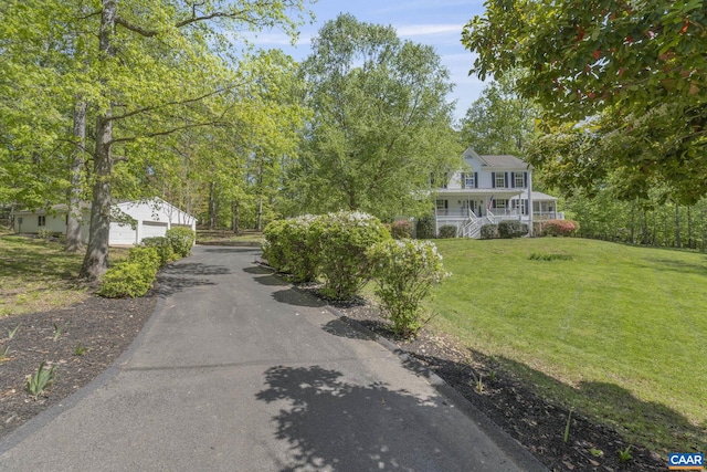 view of front facade with an outbuilding and a front yard