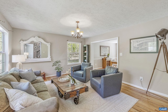 living room with a healthy amount of sunlight, baseboards, and wood finished floors