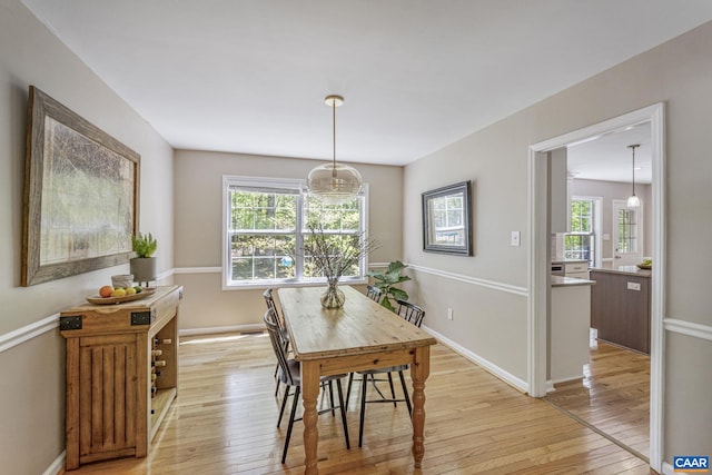 dining room with light wood-style floors and baseboards