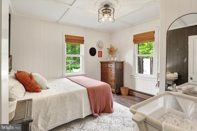 21194 Main St, Shade Gap, PA 17255 - bedroom featuring multiple windows, a baseboard heating unit, wood finished floors, and wooden walls