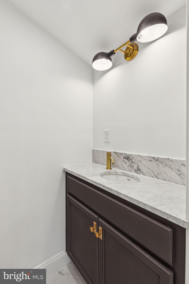 213 Morris St, Philadelphia, PA 19148 - bathroom with vanity, baseboards, and marble finish floor