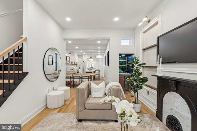 213 Morris St, Philadelphia, PA 19148 - living room featuring beverage cooler, stairs, recessed lighting, a healthy amount of sunlight, and light wood-type flooring