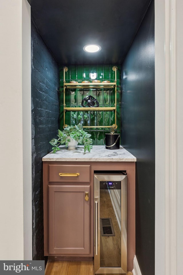 213 Morris St, Philadelphia, PA 19148 - bar with wine cooler, a bar, and wood finished floors