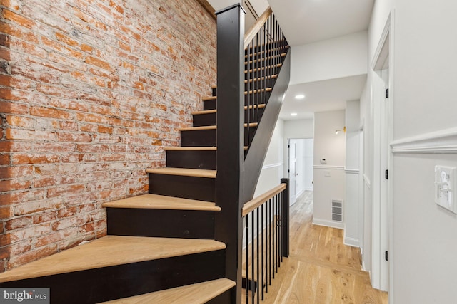 213 Morris St, Philadelphia, PA 19148 - stairway with recessed lighting, brick wall, visible vents, and wood finished floors