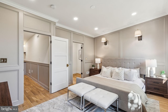 213 Morris St, Philadelphia, PA 19148 - bedroom featuring crown molding, light wood-style flooring, and a decorative wall