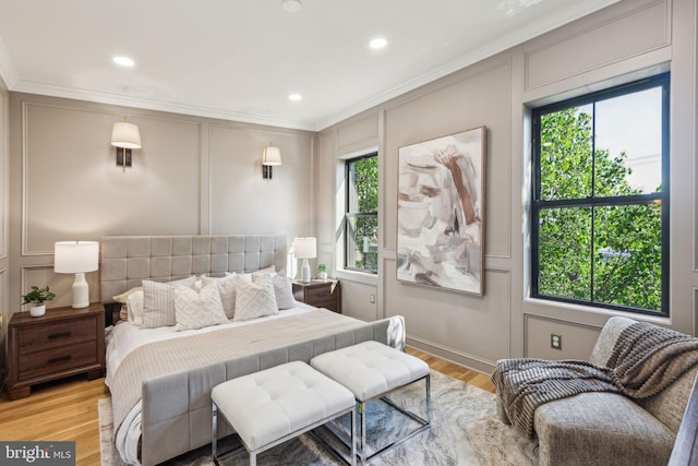 213 Morris St, Philadelphia, PA 19148 - bedroom with ornamental molding, light wood-style flooring, a decorative wall, and multiple windows