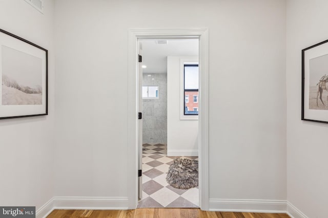 213 Morris St, Philadelphia, PA 19148 - hallway featuring baseboards, wood finished floors, and visible vents
