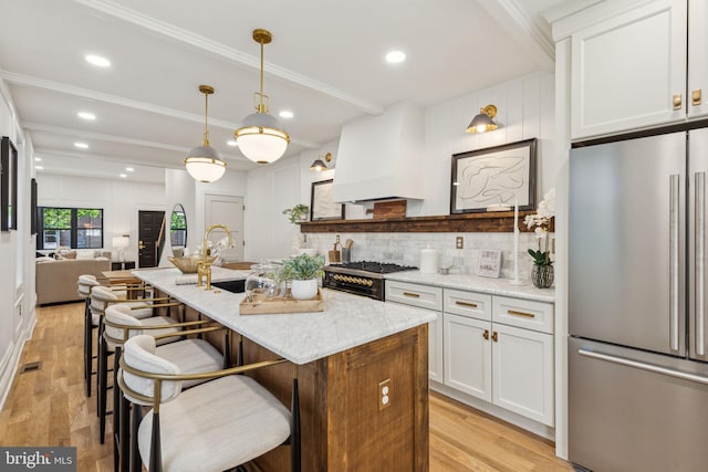 213 Morris St, Philadelphia, PA 19148 - kitchen with freestanding refrigerator, a sink, backsplash, and light wood-style flooring