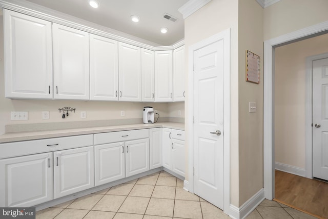 kitchen featuring light countertops, light tile patterned floors, and white cabinets
