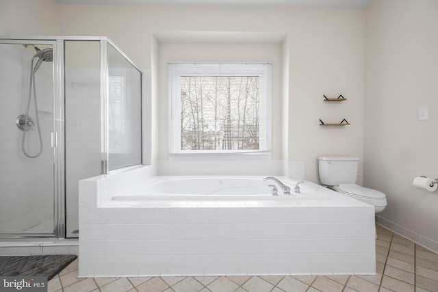 full bath featuring toilet, tile patterned flooring, a garden tub, and a stall shower