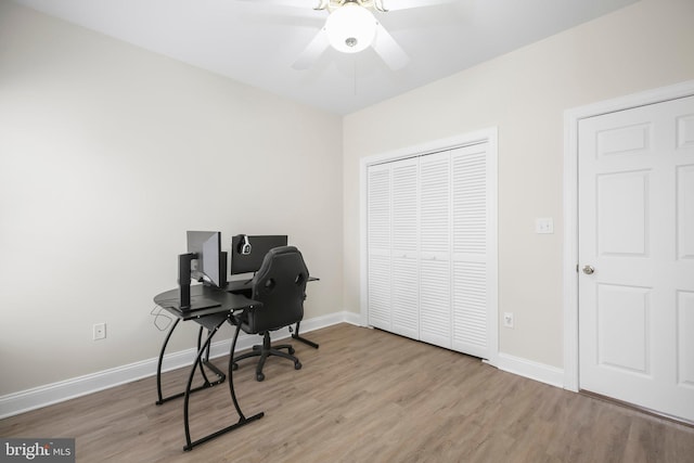 office area featuring baseboards, ceiling fan, and wood finished floors