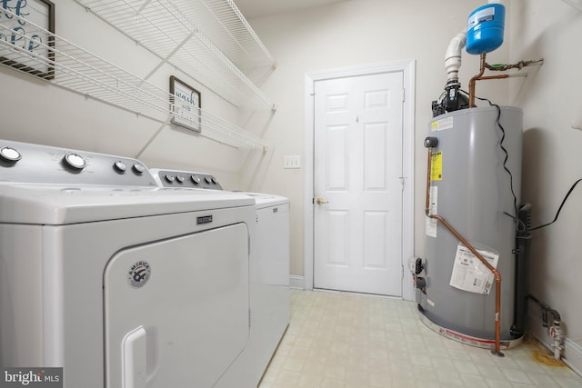 washroom with separate washer and dryer, laundry area, and gas water heater