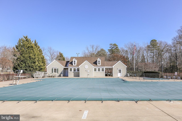 community pool featuring fence and a patio area