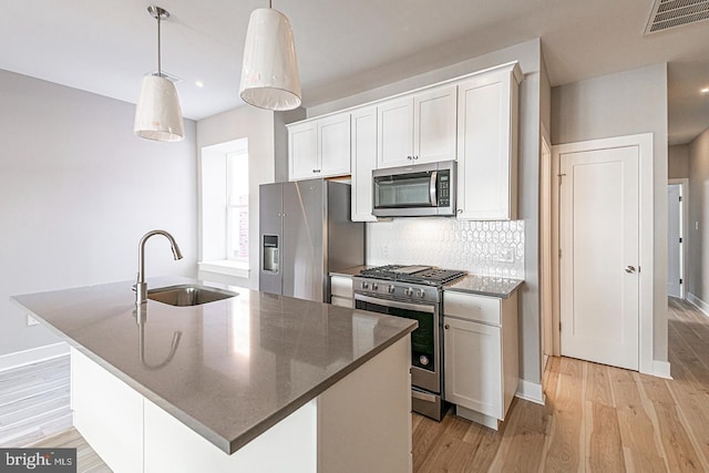 5412 Chancellor St, Philadelphia, PA 19139 - kitchen featuring visible vents, a center island with sink, a sink, light wood-style flooring, and stainless steel appliances