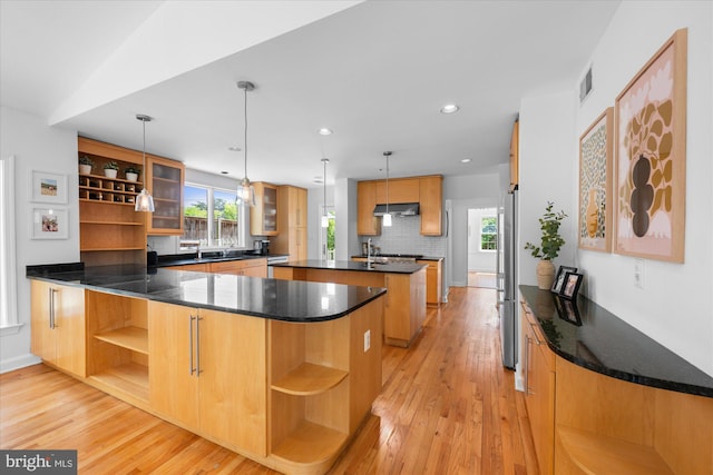 kitchen with visible vents, open shelves, a peninsula, under cabinet range hood, and light wood-style flooring