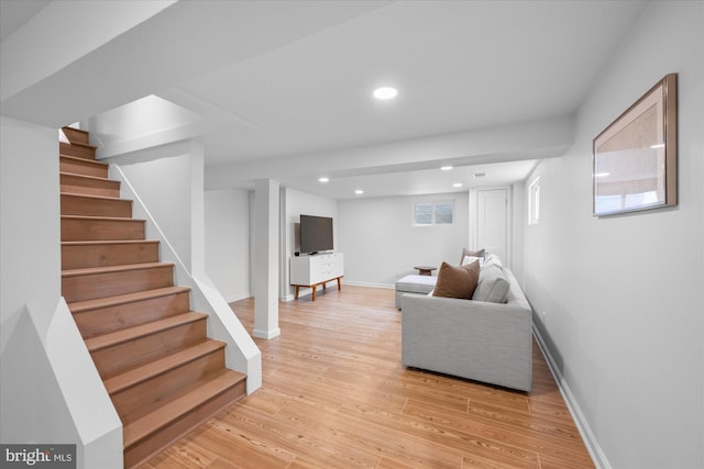living room featuring recessed lighting, baseboards, light wood finished floors, and stairs