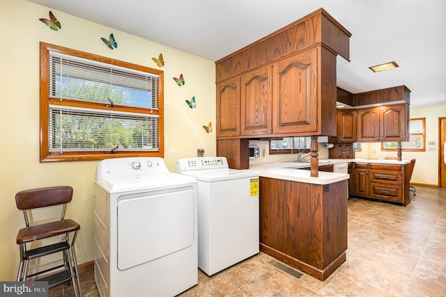 laundry room with cabinet space, visible vents, washing machine and dryer, and plenty of natural light