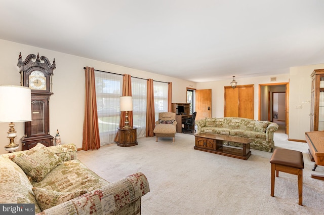 living area featuring light carpet