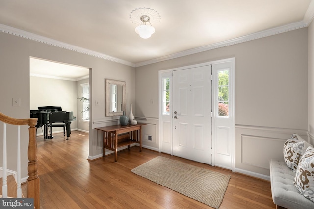 10808 Fieldwood Dr, Fairfax, VA 22030 - foyer entrance featuring plenty of natural light, ornamental molding, light wood-style flooring, a decorative wall, and stairway