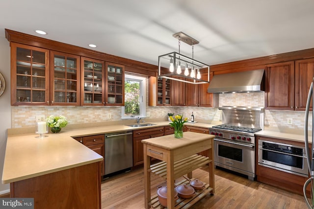 10808 Fieldwood Dr, Fairfax, VA 22030 - kitchen featuring wall chimney exhaust hood, appliances with stainless steel finishes, light countertops, backsplash, and recessed lighting